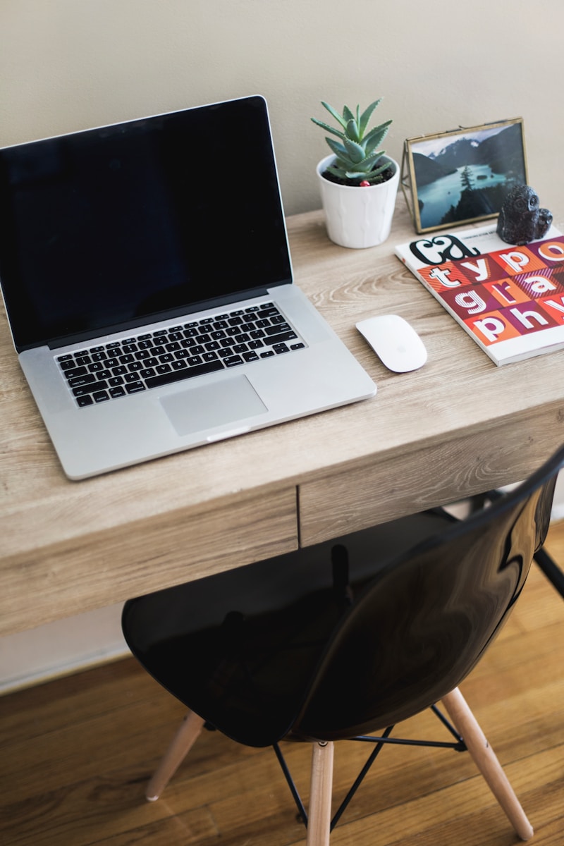 MacBook Pro on table with Magic Mouse